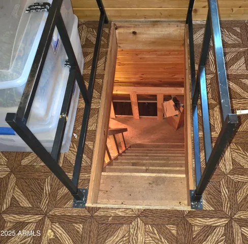 a view of a room with wooden floor and door