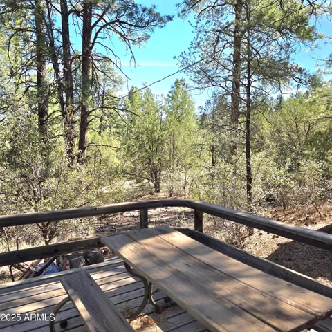 a view of a balcony with wooden floor and fence