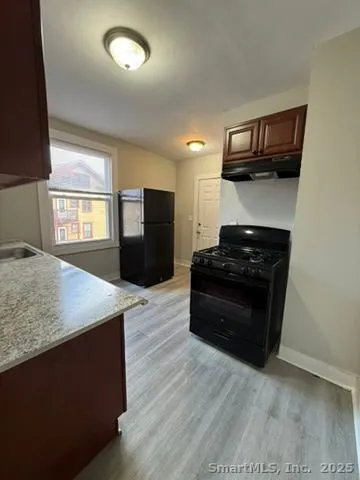 a kitchen with a appliances wooden cabinets and a counter top space