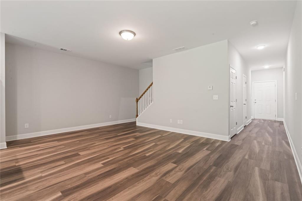 2707 Hickory Lane Dawsonville, GA 30534 - Photo 11 of 31 a view of an empty room with wooden floor and a window