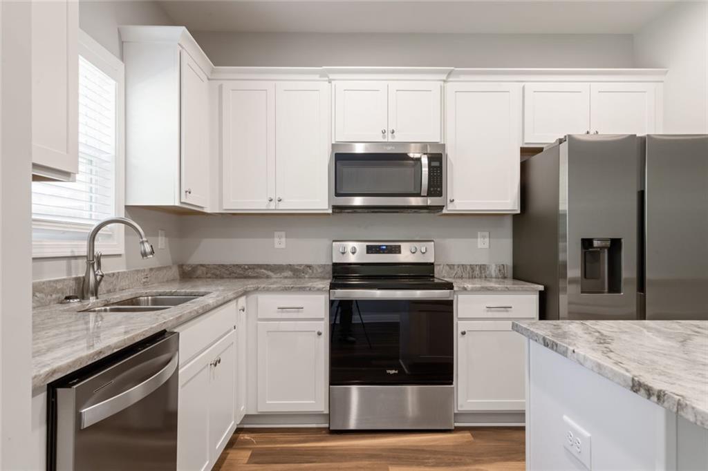 2707 Hickory Lane Dawsonville, GA 30534 - Photo 16 of 31 a kitchen with stainless steel appliances granite countertop a stove a sink and a microwave