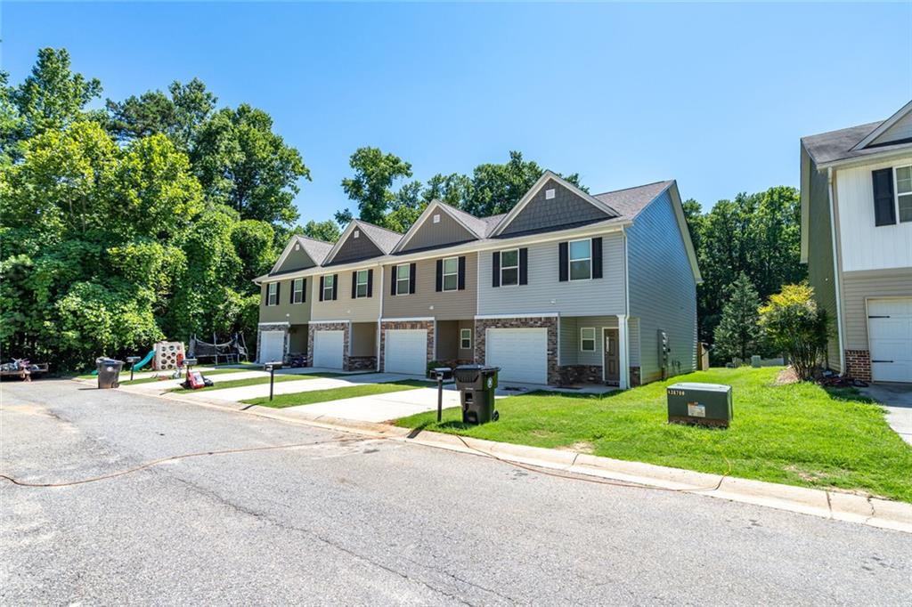 2707 Hickory Lane Dawsonville, GA 30534 - Photo 4 of 31 a front view of a house with garden and trees