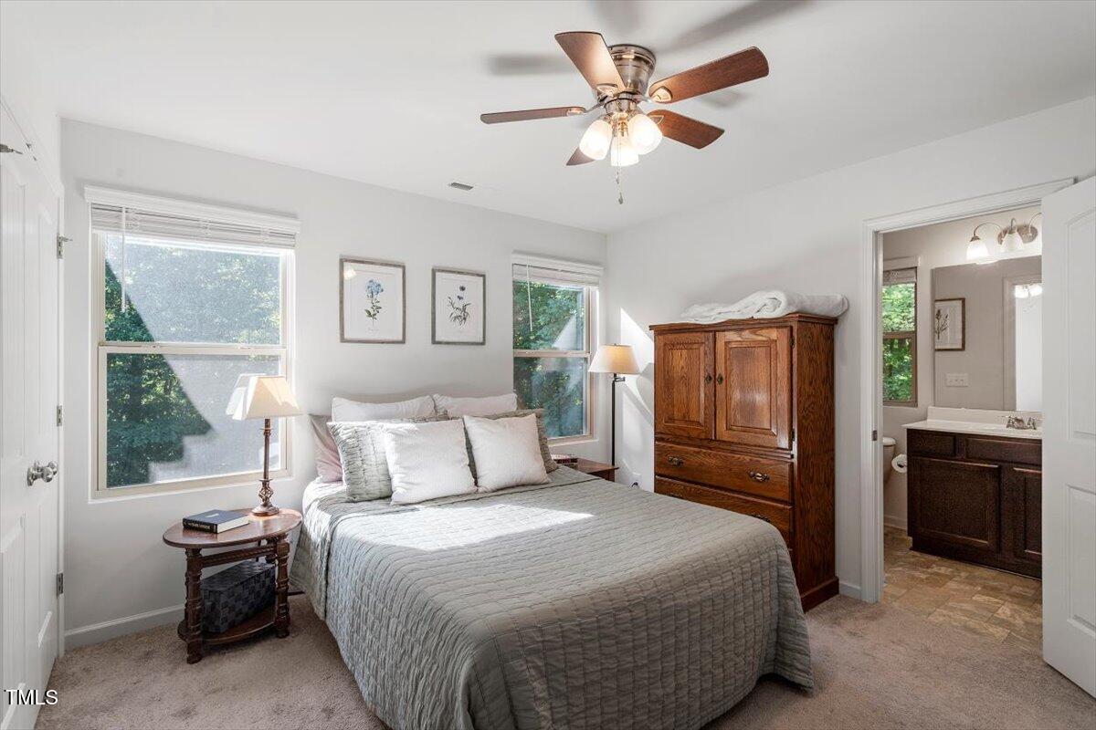 534 Hobkirks Place Durham, NC 27704 - Photo 20 of 34 a bedroom with a large bed and a chandelier