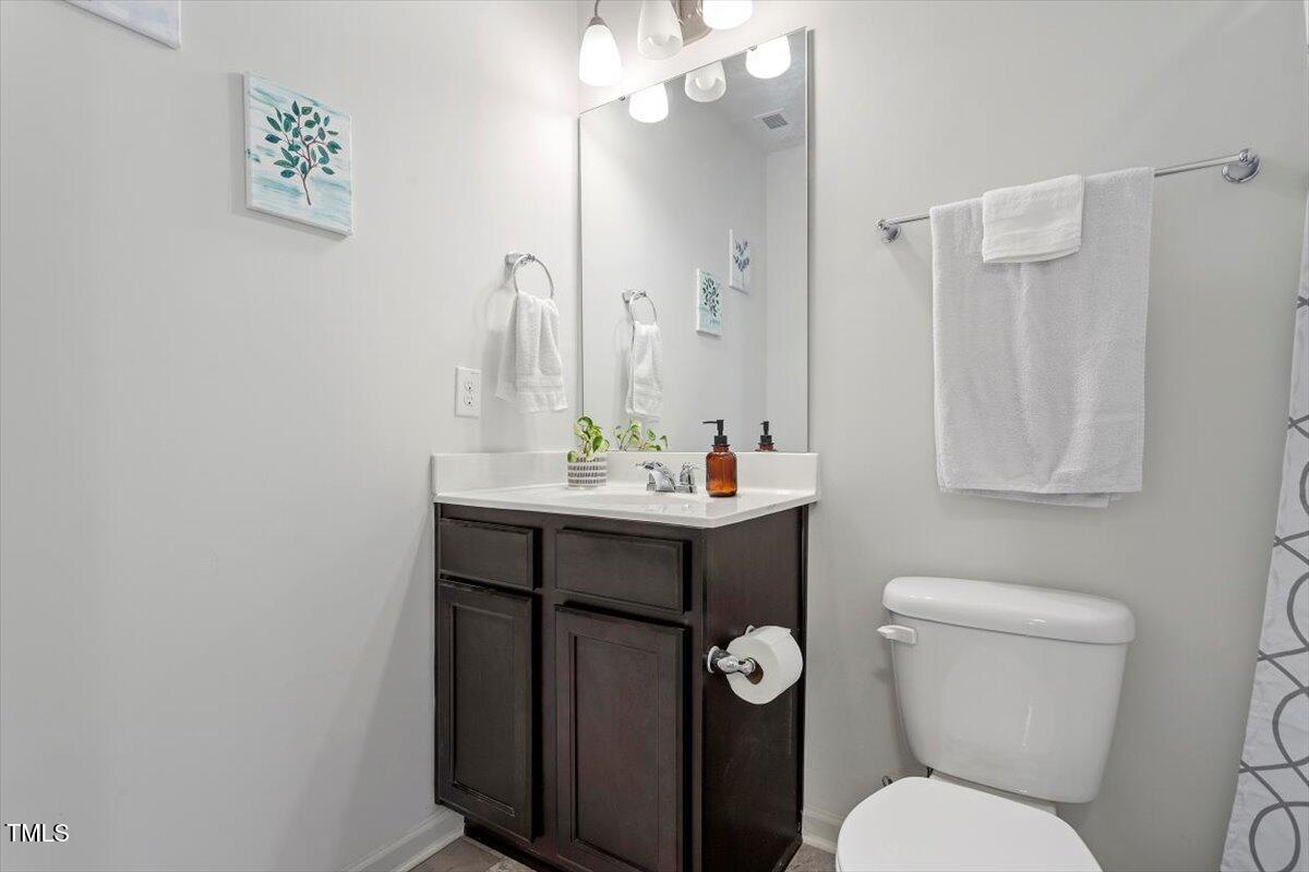534 Hobkirks Place Durham, NC 27704 - Photo 28 of 34 a bathroom with a toilet sink and mirror