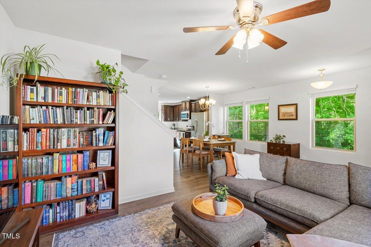 534 Hobkirks Place Durham, NC 27704 - Photo 4 of 34 a living room with furniture a bookshelf and a book shelf
