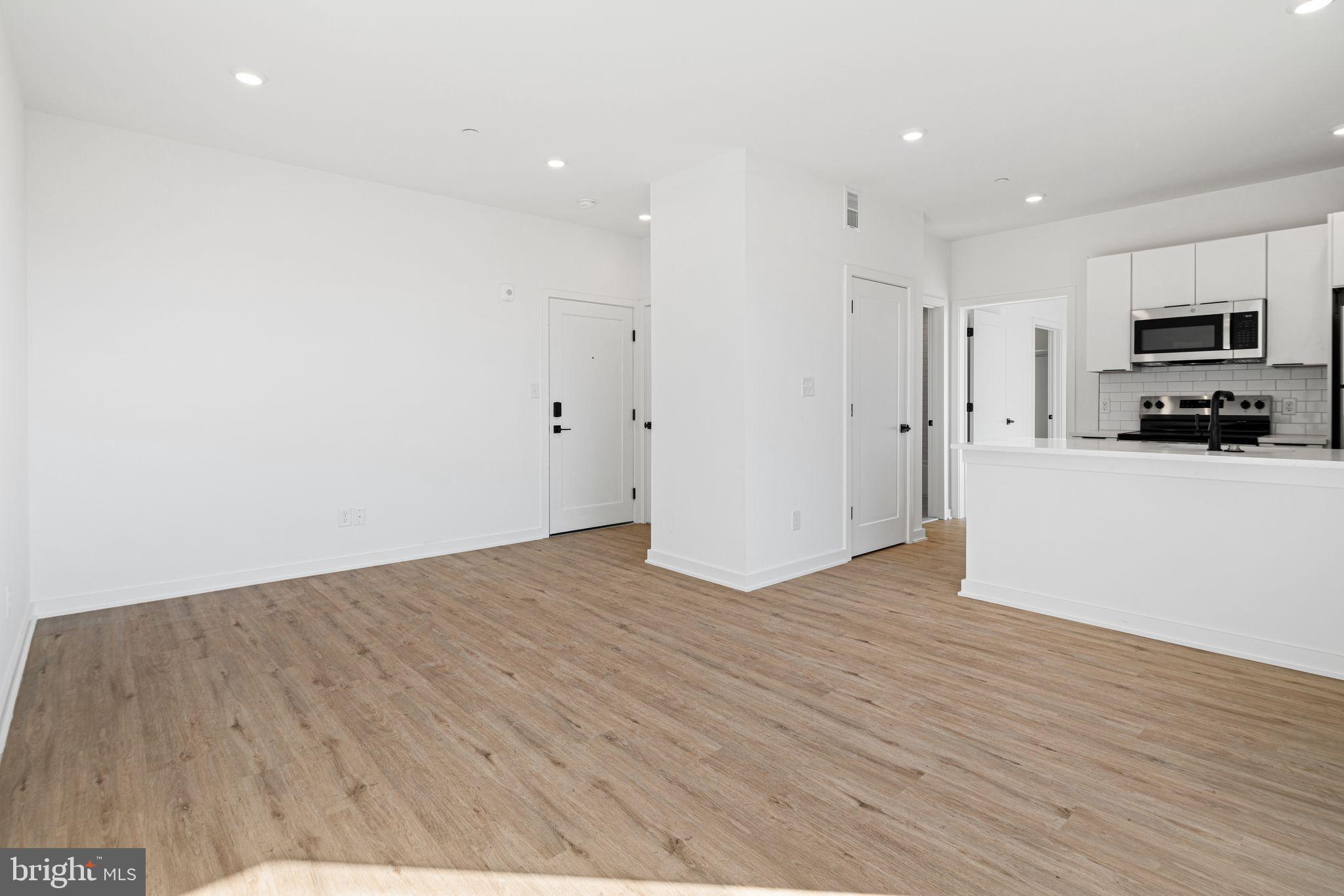 a view of a kitchen with wooden floor
