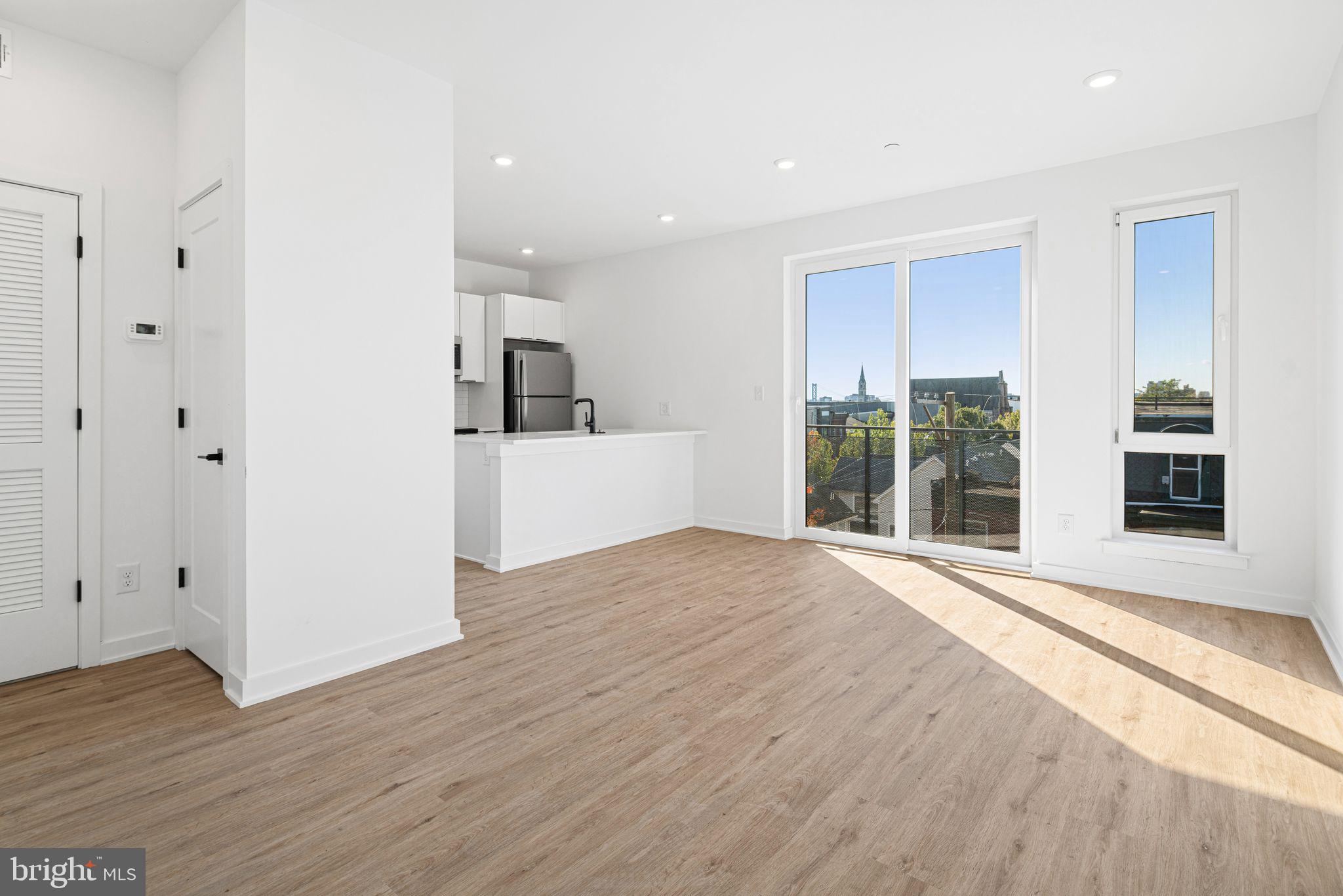 701 Cecil B. Moore Avenue, Unit 2 Philadelphia, PA 19122 - Photo 4 of 13 a view of a kitchen with wooden floor and a window