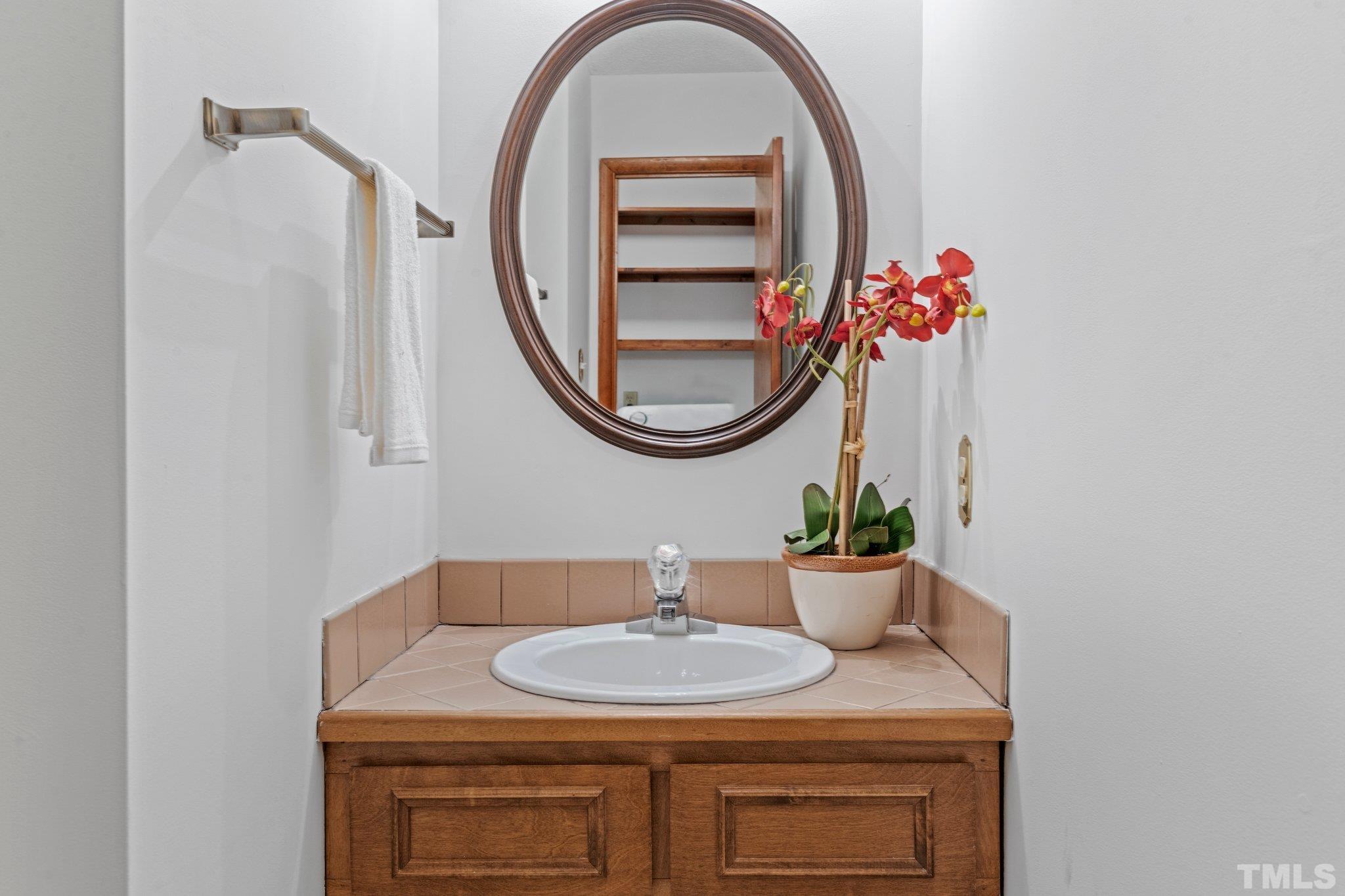 7829 Breckon Way Raleigh, NC 27615 - Photo 14 of 40 a bathroom with a sink and a mirror