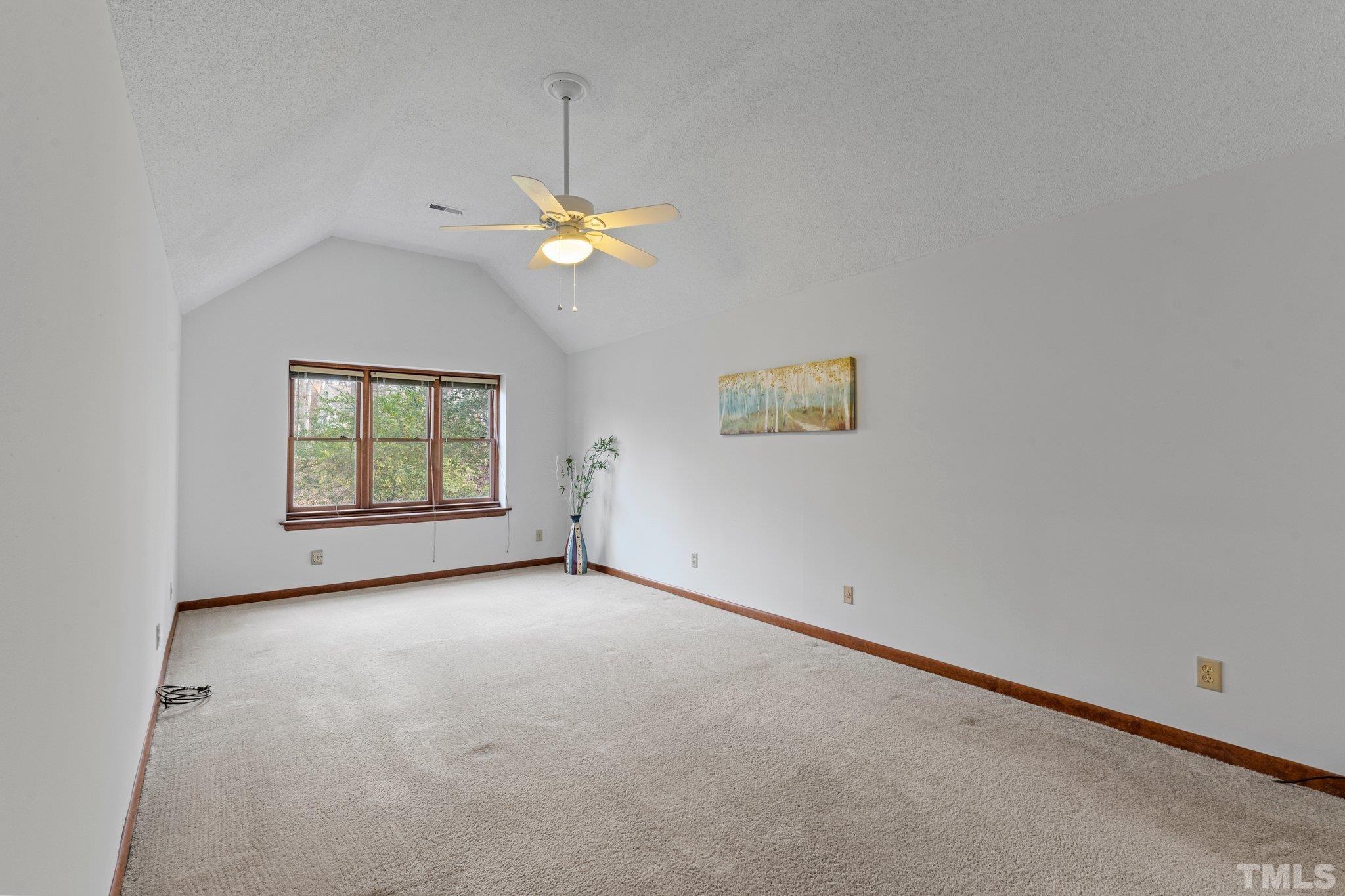 7829 Breckon Way Raleigh, NC 27615 - Photo 16 of 40 an empty room with windows and ceiling fan
