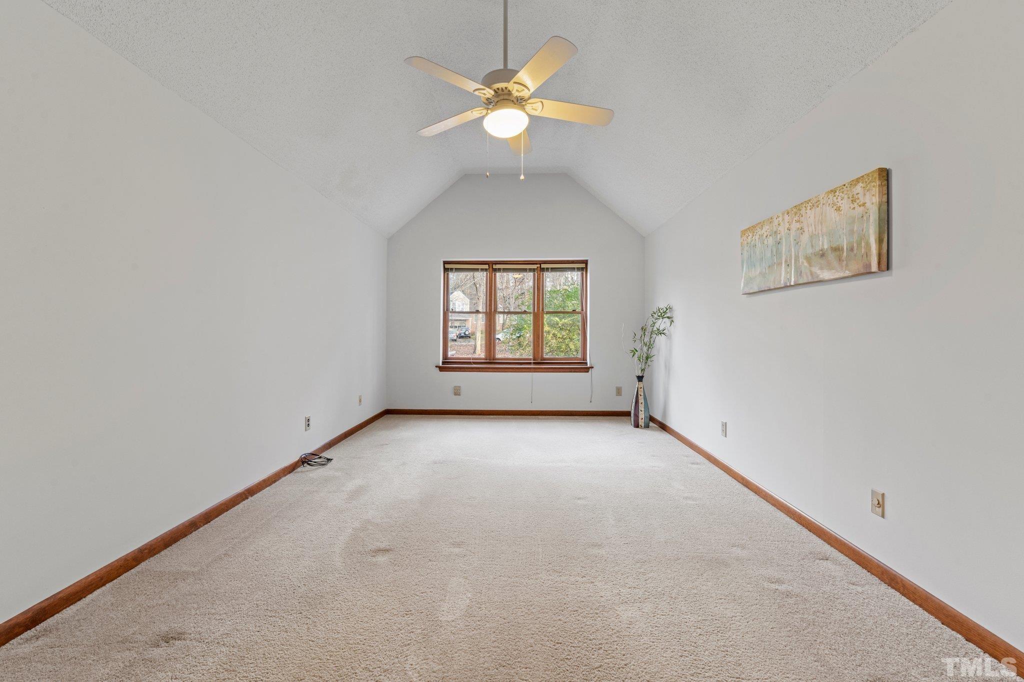 7829 Breckon Way Raleigh, NC 27615 - Photo 17 of 40 an empty room with a window and a ceiling fan