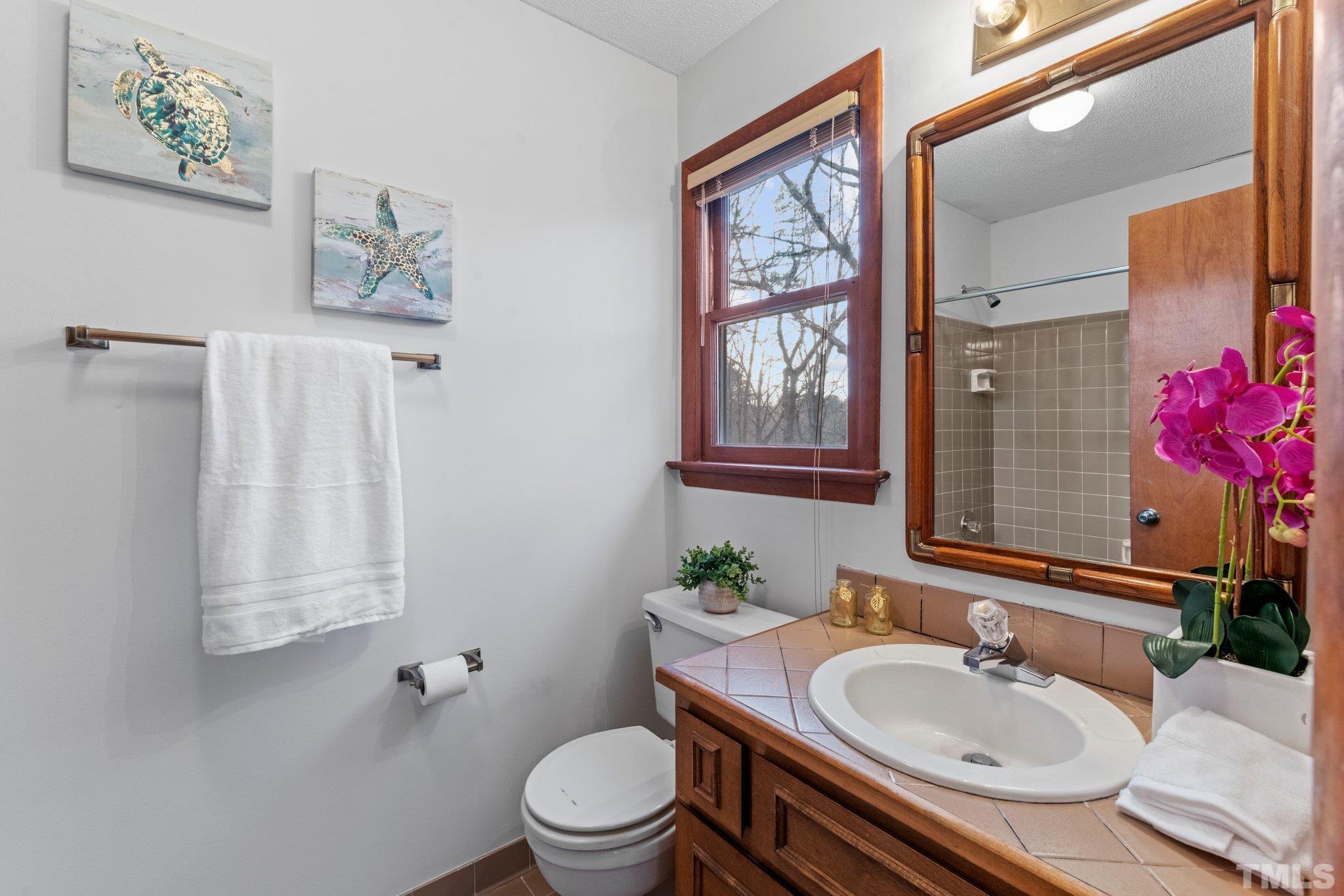 7829 Breckon Way Raleigh, NC 27615 - Photo 22 of 40 a bathroom with a sink toilet and shower