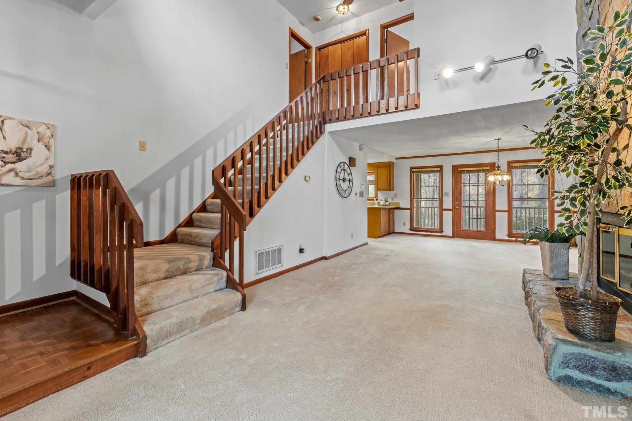 7829 Breckon Way Raleigh, NC 27615 - Photo 4 of 40 a view of an entryway with staircase