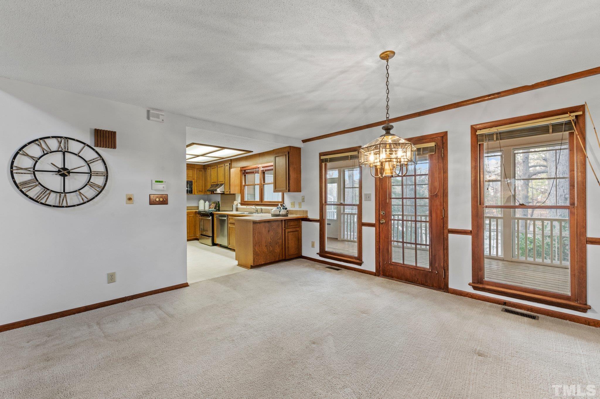 7829 Breckon Way Raleigh, NC 27615 - Photo 8 of 40 a view of living room kitchen with furniture and window