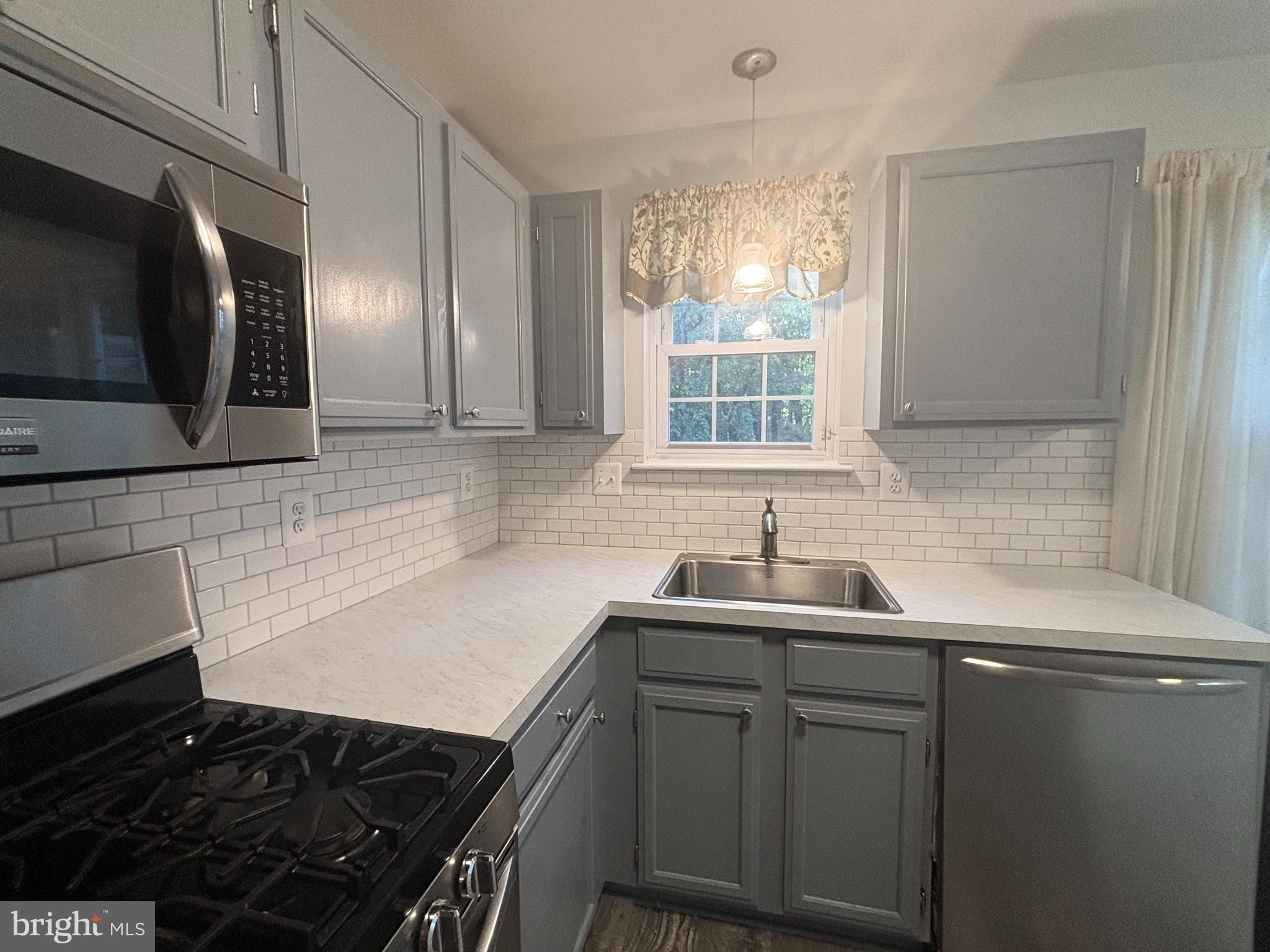 307 Tall Pines Court, Unit 3 Abingdon, MD 21009 - Photo 11 of 52 a kitchen with a sink stove and microwave