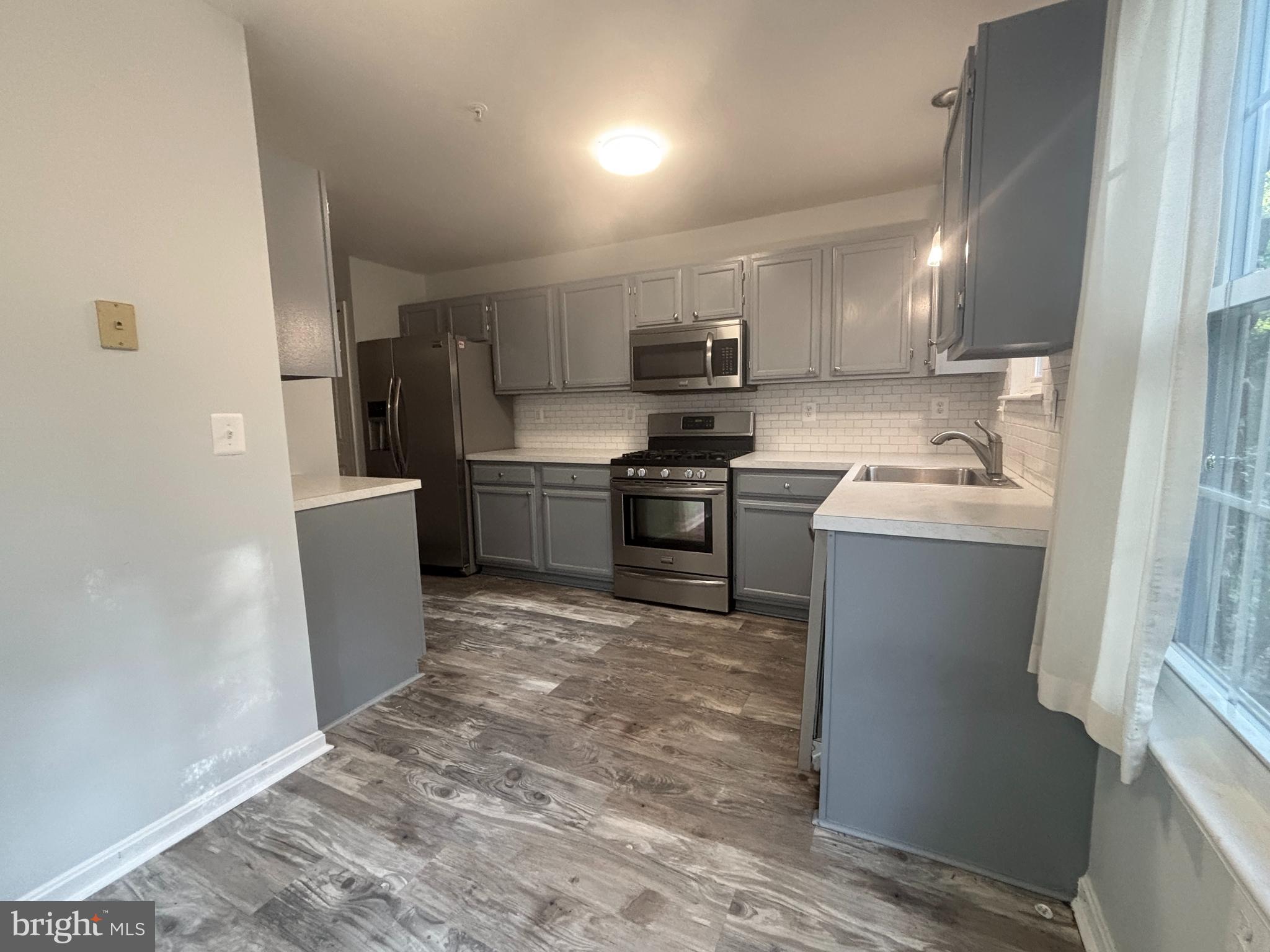 307 Tall Pines Court, Unit 3 Abingdon, MD 21009 - Photo 12 of 52 a kitchen with stainless steel appliances granite countertop a sink stove and refrigerator