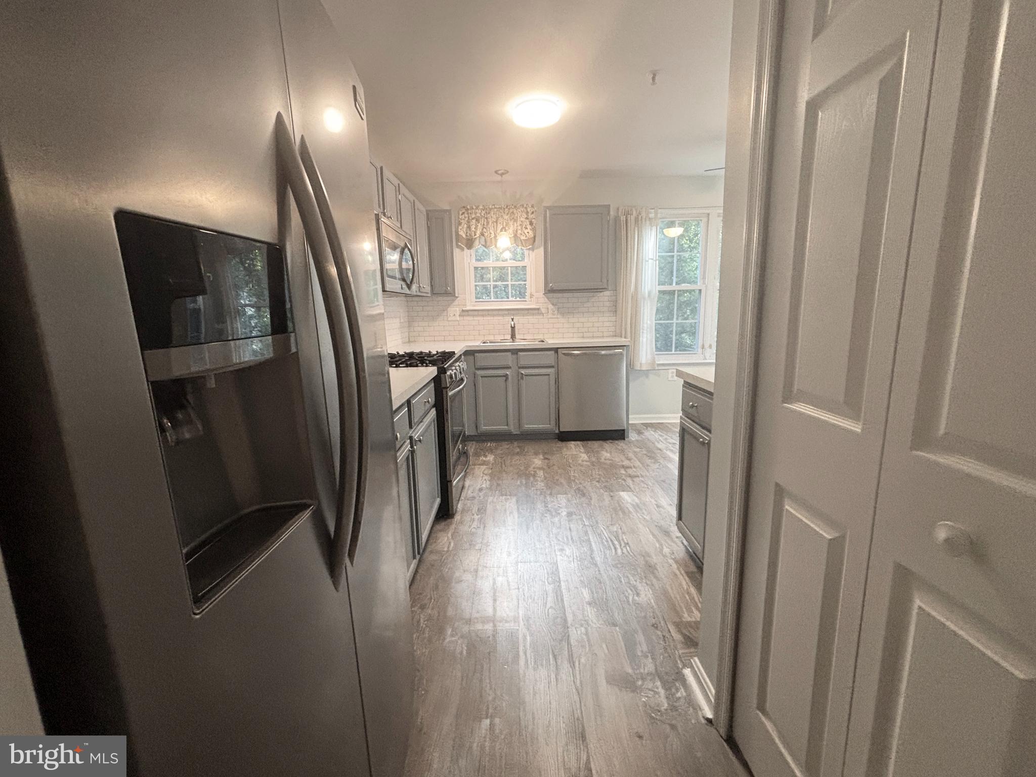 307 Tall Pines Court, Unit 3 Abingdon, MD 21009 - Photo 14 of 52 a kitchen with a refrigerator a sink and wooden floor