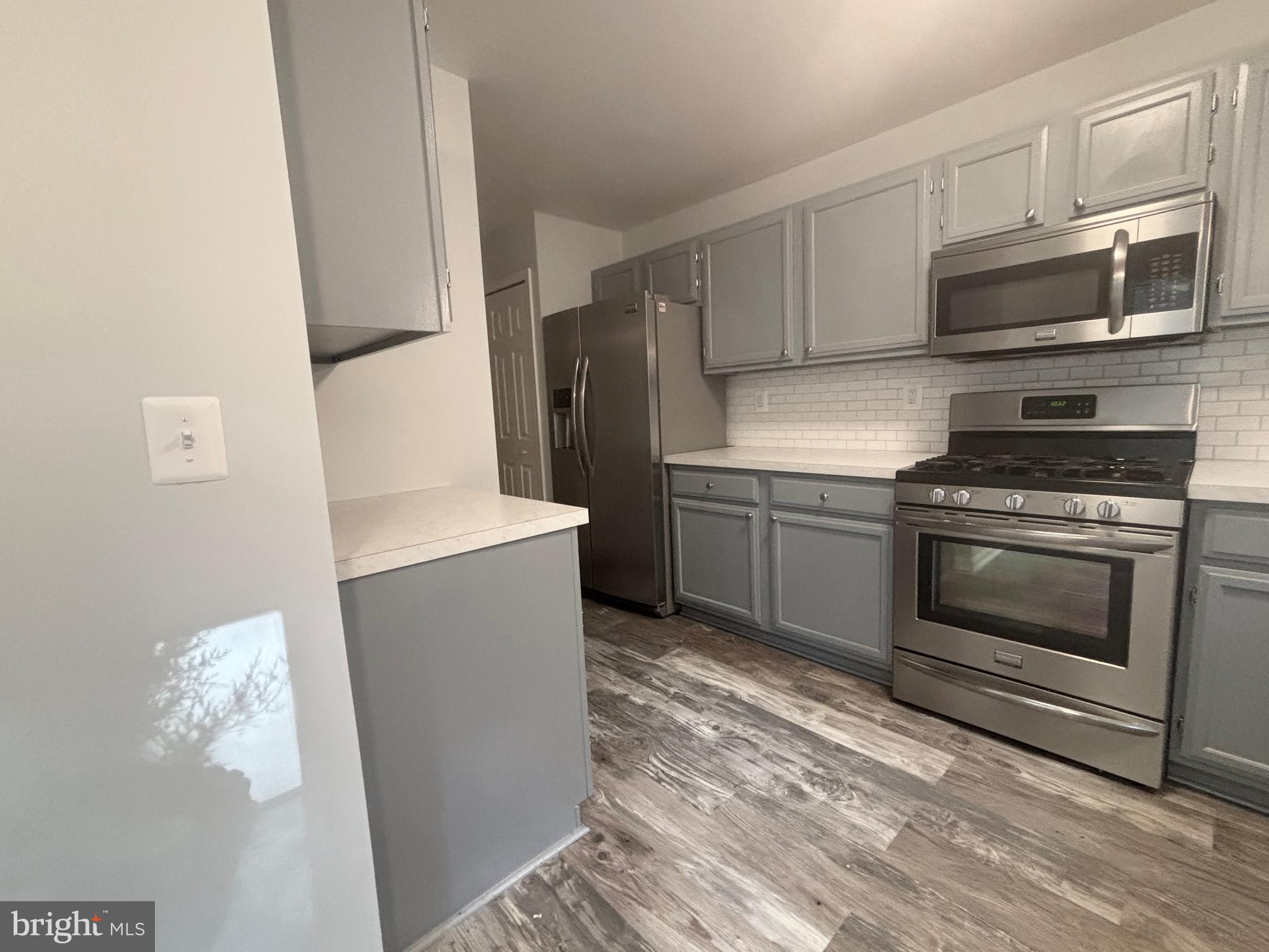307 Tall Pines Court, Unit 3 Abingdon, MD 21009 - Photo 16 of 52 a kitchen with granite countertop a stove and a refrigerator