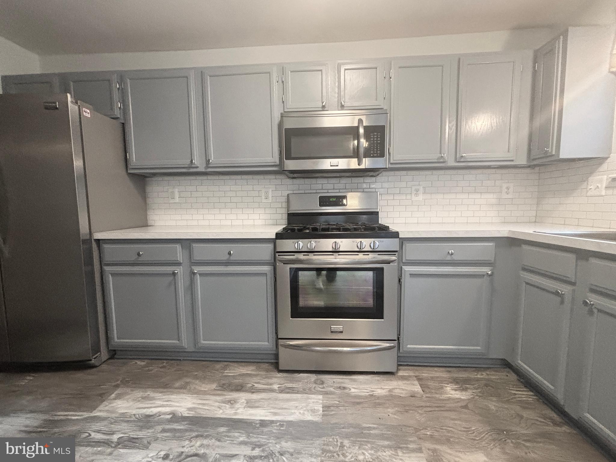 307 Tall Pines Court, Unit 3 Abingdon, MD 21009 - Photo 18 of 52 a kitchen with white cabinets and stainless steel appliances