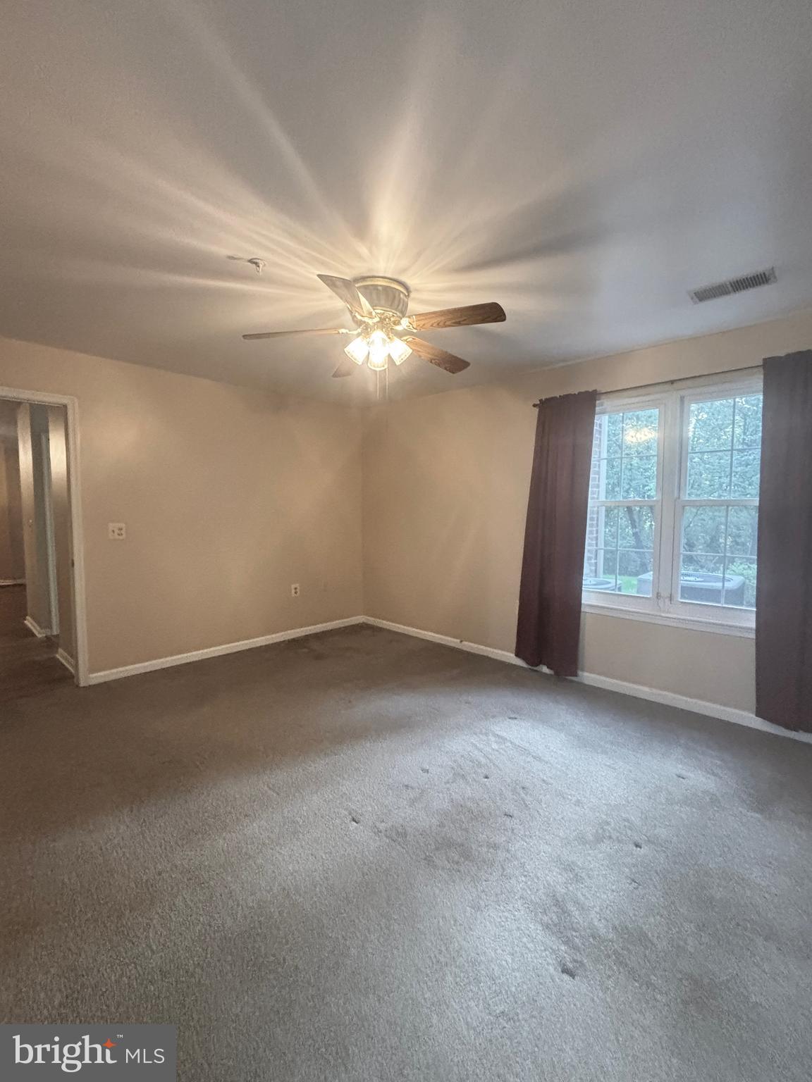 307 Tall Pines Court, Unit 3 Abingdon, MD 21009 - Photo 26 of 52 an empty room with windows and chandelier fan