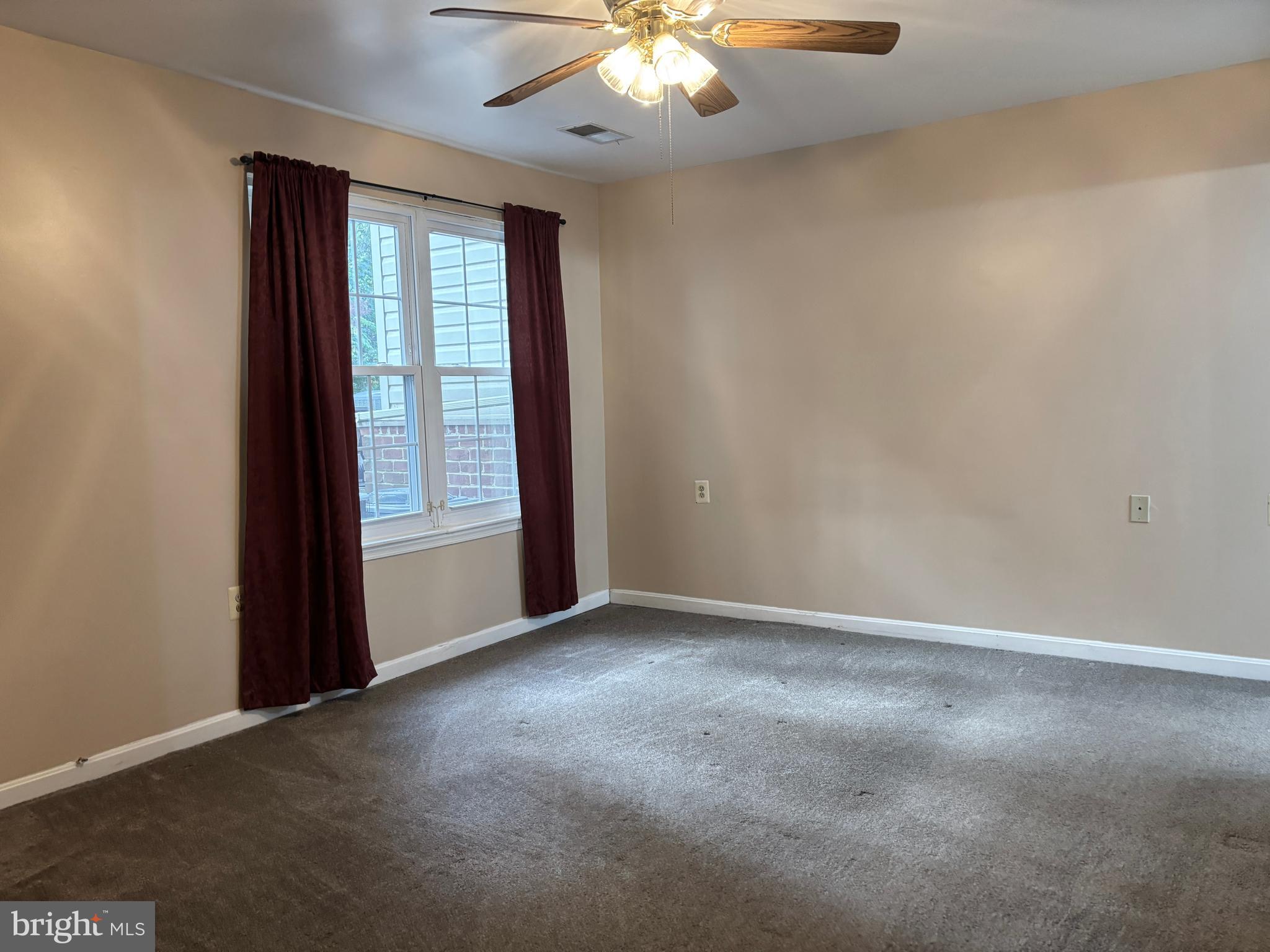 307 Tall Pines Court, Unit 3 Abingdon, MD 21009 - Photo 27 of 52 an empty room with a chandelier fan and windows