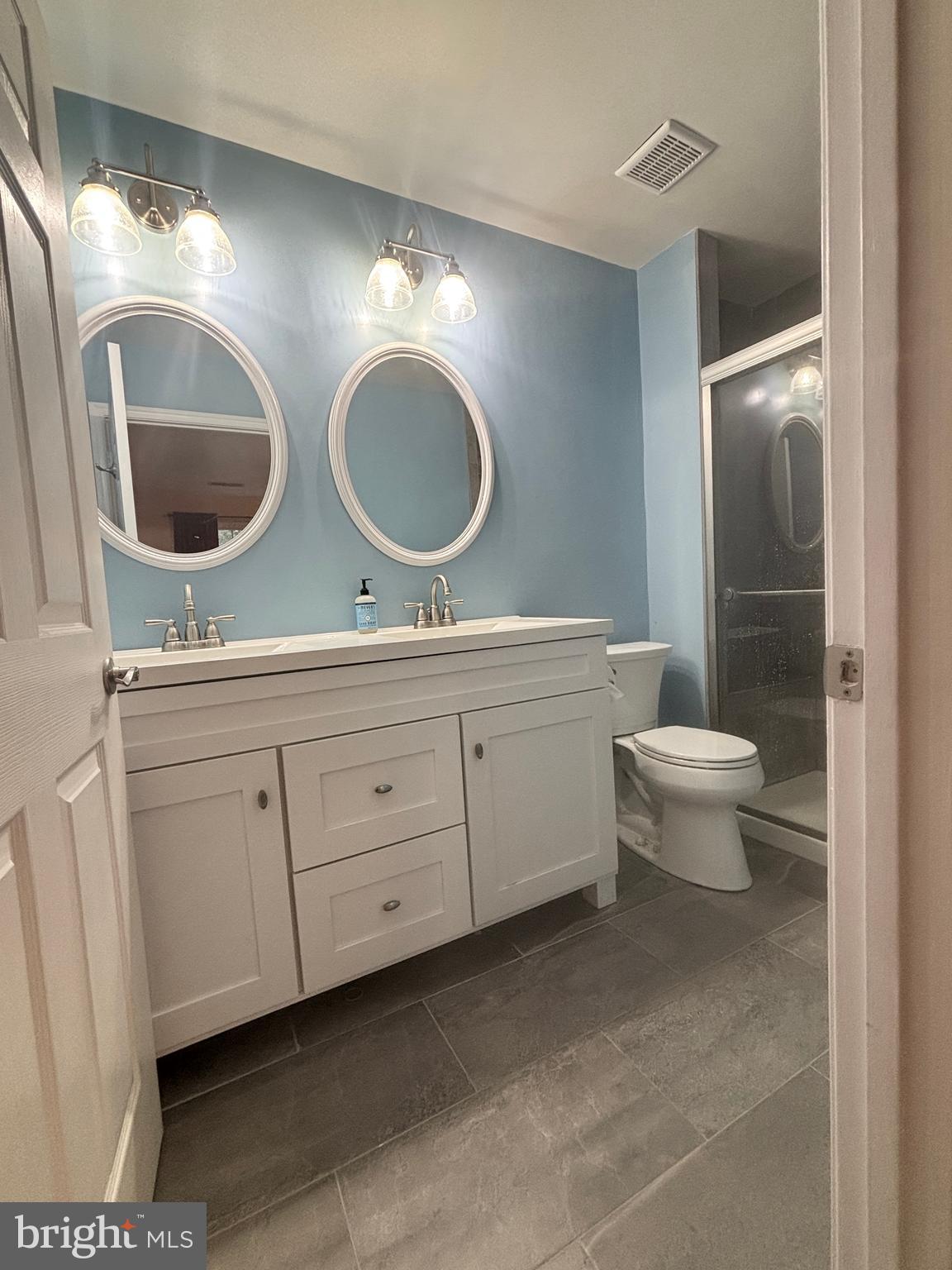 307 Tall Pines Court, Unit 3 Abingdon, MD 21009 - Photo 30 of 52 a bathroom with a toilet a double vanity sink and a mirror