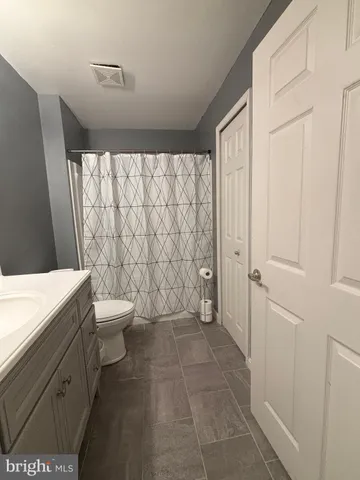 a bathroom with a toilet a sink and shower