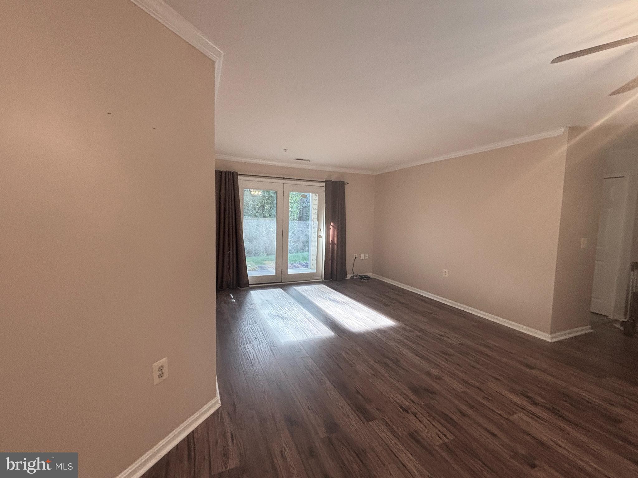 307 Tall Pines Court, Unit 3 Abingdon, MD 21009 - Photo 4 of 52 a view of an empty room with wooden floor and a window