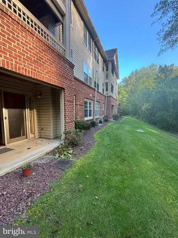 a view of a brick building next to a big yard
