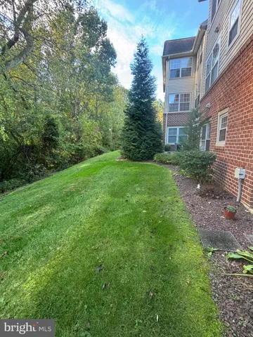 a view of a brick house with a yard