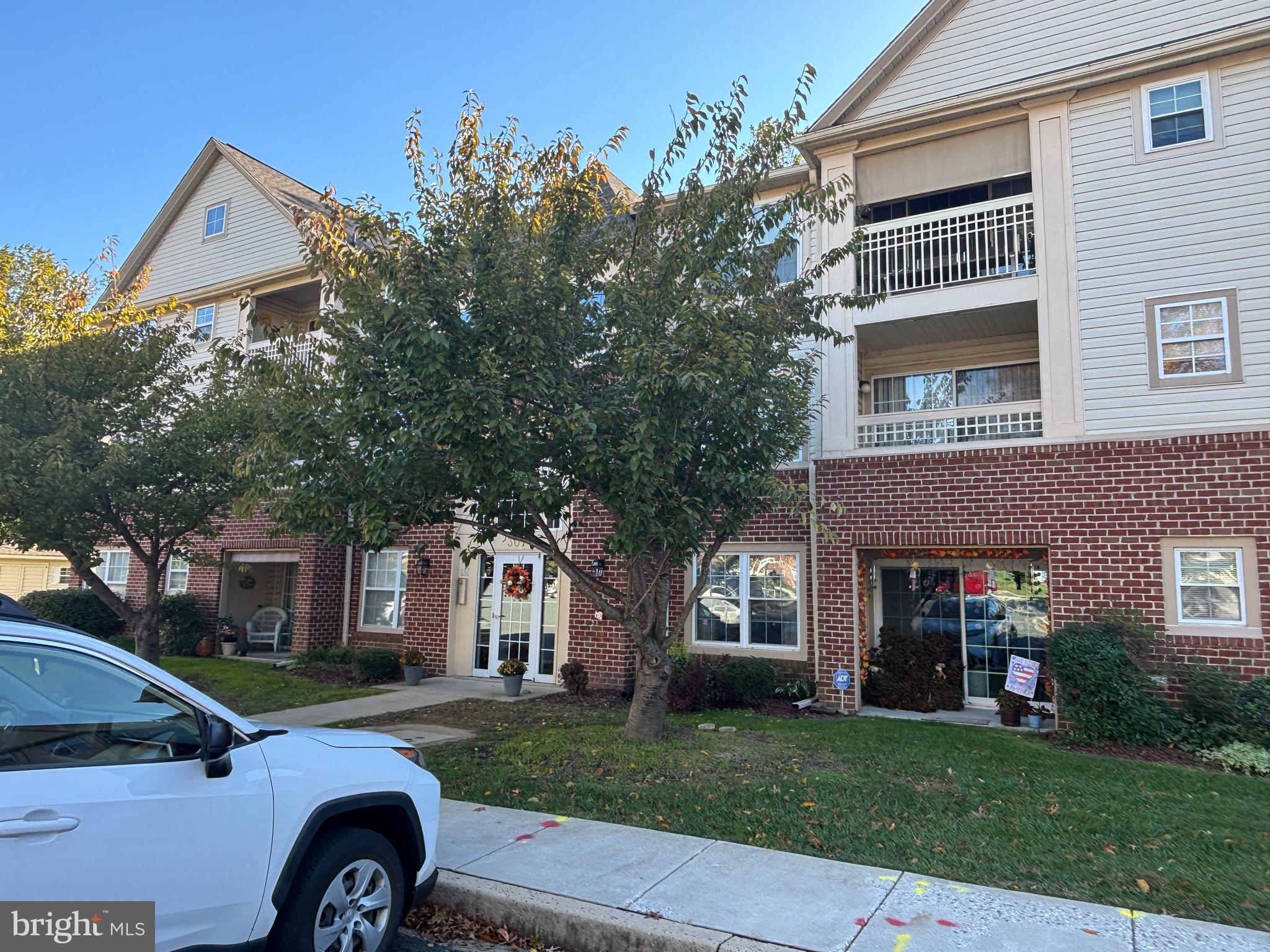 307 Tall Pines Court, Unit 3 Abingdon, MD 21009 - Photo 51 of 52 a front view of a house with a garden and tree