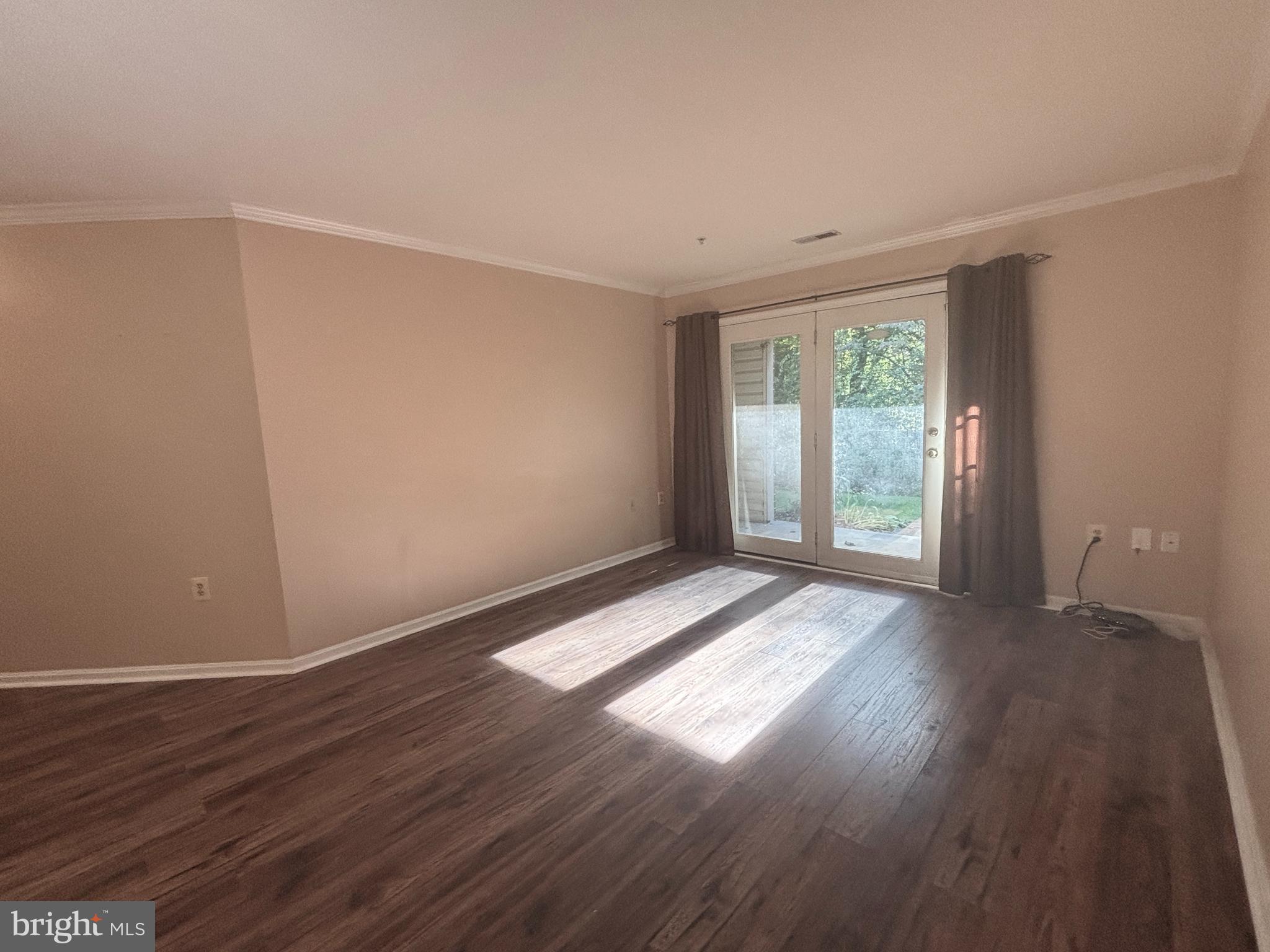 307 Tall Pines Court, Unit 3 Abingdon, MD 21009 - Photo 6 of 52 a view of an empty room with wooden floor and a window