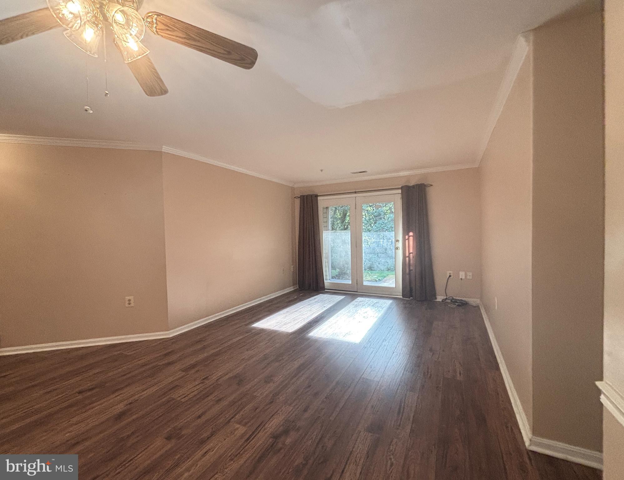 307 Tall Pines Court, Unit 3 Abingdon, MD 21009 - Photo 7 of 52 a view of an empty room with wooden floor and a window