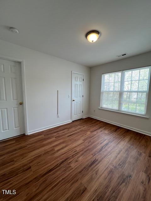 53 Red Lane Raleigh, NC 27606 - Photo 9 of 13 an empty room with wooden floor and windows