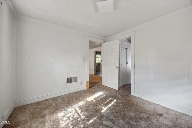 a view of a big room with wooden floor and windows