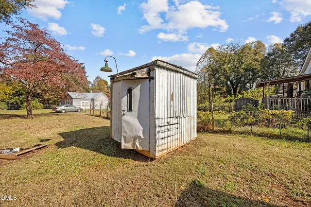 a view of a house with snow on the side of the road