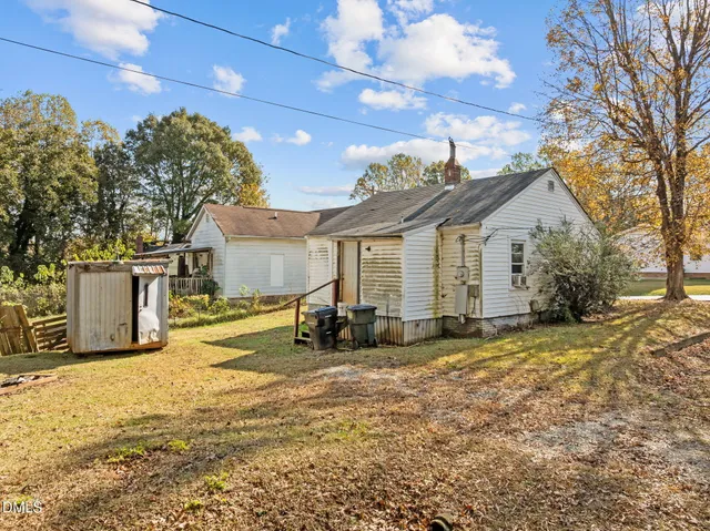 a front view of a house with a yard outdoor seating and garage