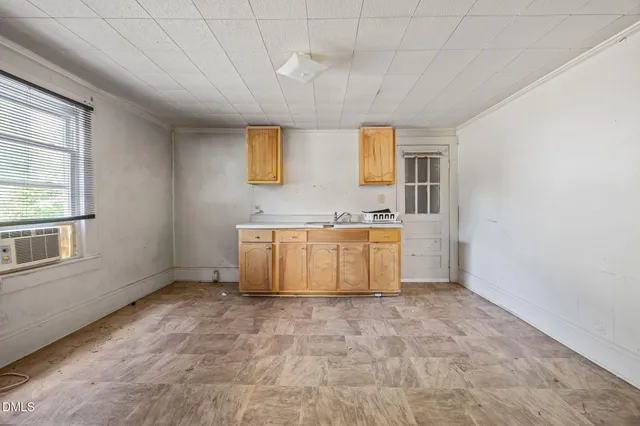 a view of a kitchen with a sink dishwasher cabinet and a window