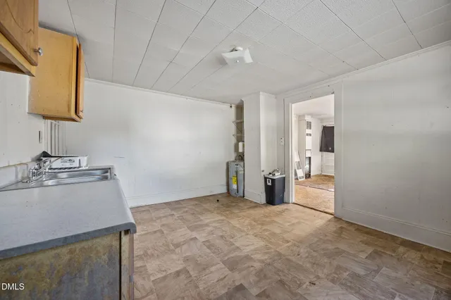 a view of a room that has a sink and a mirror in it