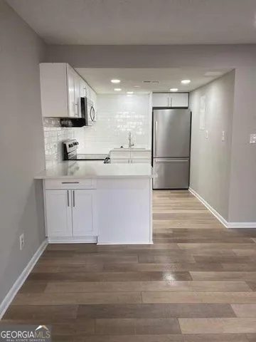 a kitchen with kitchen island sink stove and refrigerator
