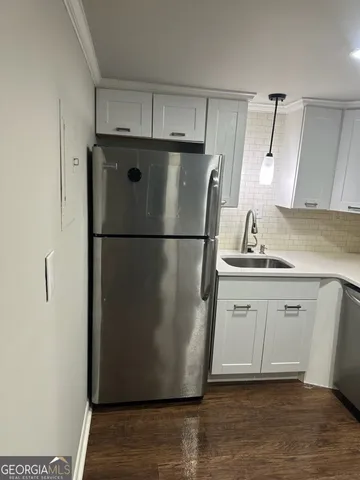 a kitchen with a refrigerator a sink and dishwasher