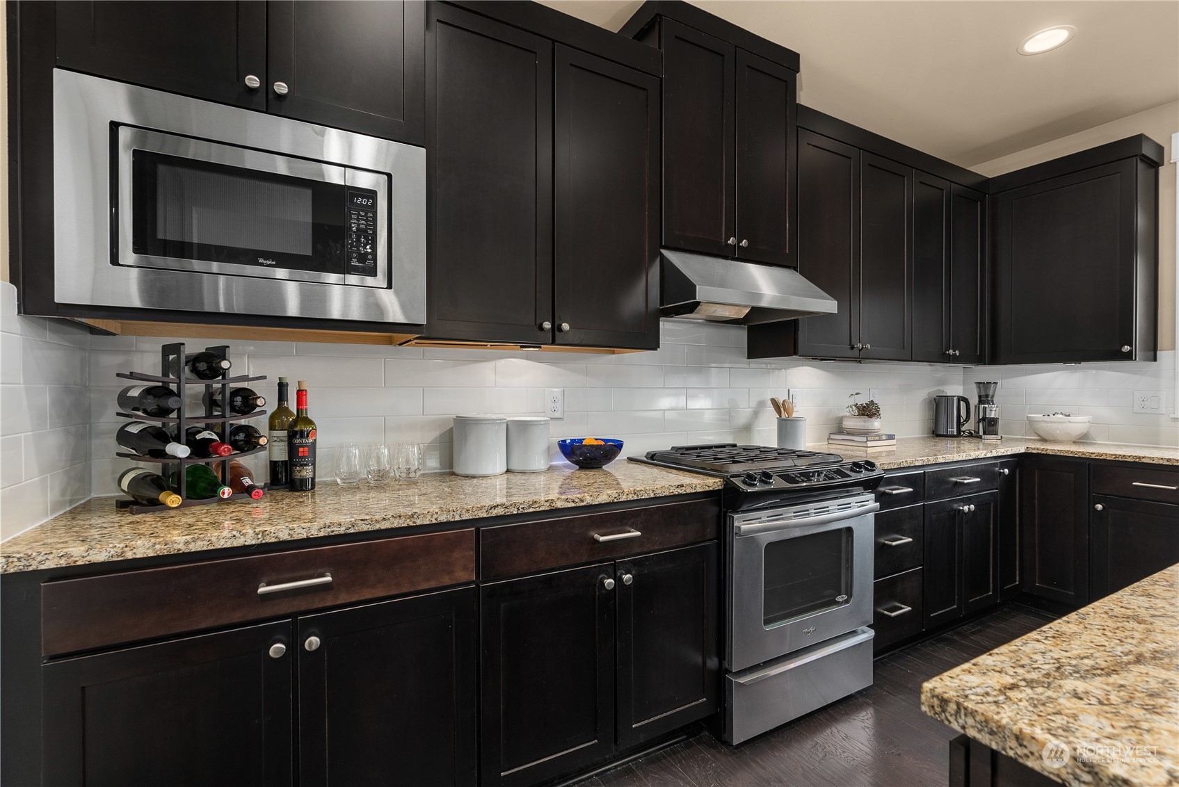 855 Lyons Avenue Northeast Renton, WA 98059 - Photo 9 of 37 a kitchen with stainless steel appliances granite countertop wooden cabinets a stove a microwave and sink