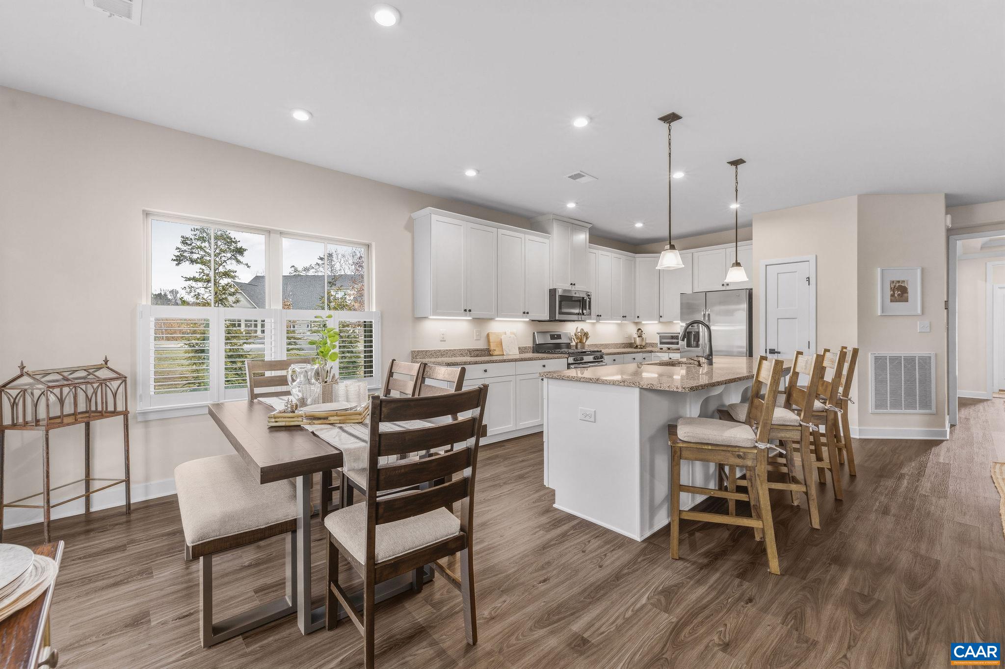 360 Winding Road Keswick, VA 22947 - Photo 18 of 48 a dining room with stainless steel appliances kitchen island granite countertop a table chairs and a living room