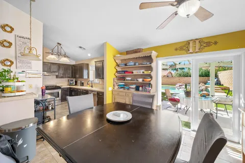 a kitchen with stainless steel appliances granite countertop a refrigerator a stove and white cabinets with wooden floors