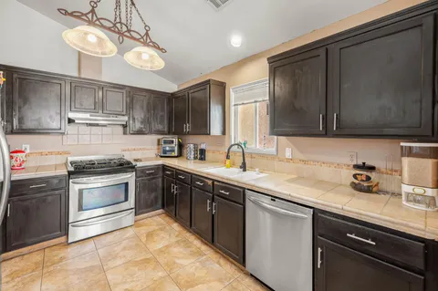a kitchen with a sink cabinets and stainless steel appliances