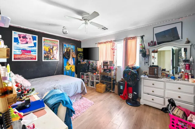a bed room with a bed furniture and a flat tv screen