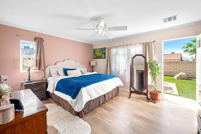 a bedroom with a bed couch and a chandelier