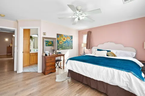 a bedroom with a bed and a chandelier