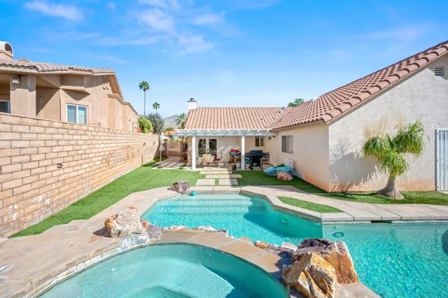 a front view of a house with a yard table and chairs