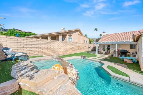 a view of an house with backyard space and garden