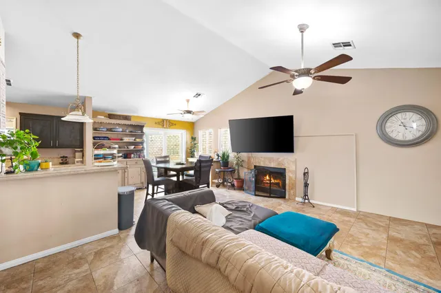 a living room with furniture a fireplace and a flat screen tv